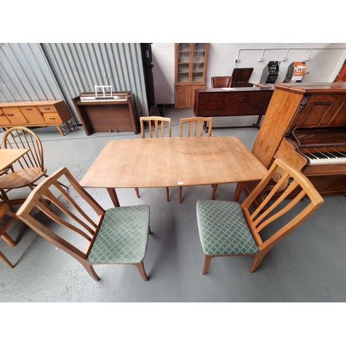 121 - A teak extending McIntosh dining table and four chairs