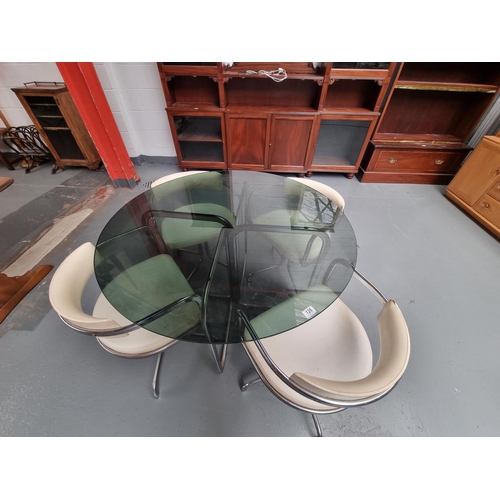 126 - A circular smoke glass and chrome dining table and four chairs