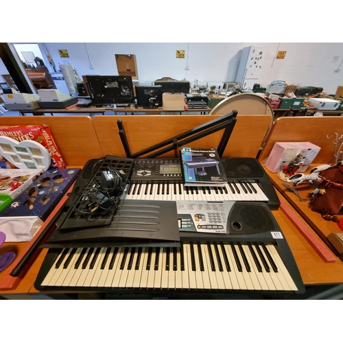 671 - A Casio WK 1300 keyboard and a Yamaha PSR 175 keyboard with one stand