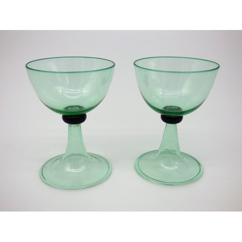 29 - Vittorio Zecchin for MVM Cappelin and Venini, two transparent pale green wine glasses designed in 19... 