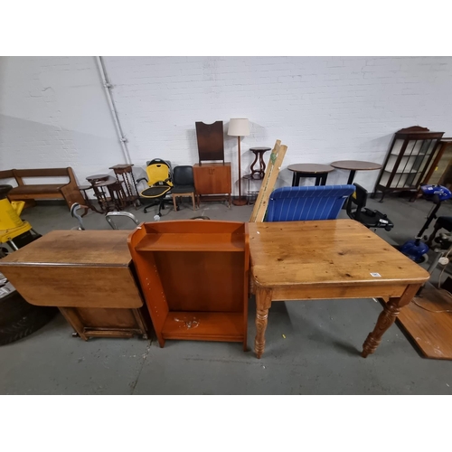 541 - A pine table, oak drop leaf table and a small bookcase