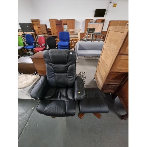 581 - Black leather swivel chair and footstool