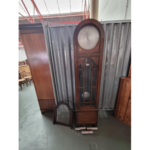 136 - An oak cased Grandfather clock with weights and pendulum