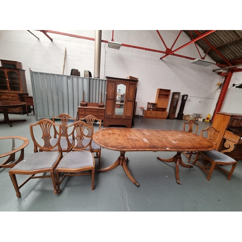 125 - A twin pedestal dining table with six chairs and one extra leaf