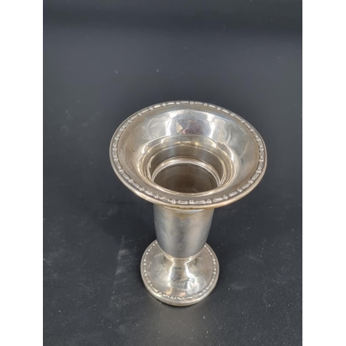 215 - A hallmarked silver vase - 6 inches tall - engraved inscription on the base - weighted base. Total w... 