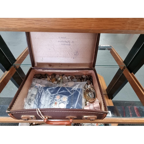 238 - A suitcase containing a large quantity of world coins