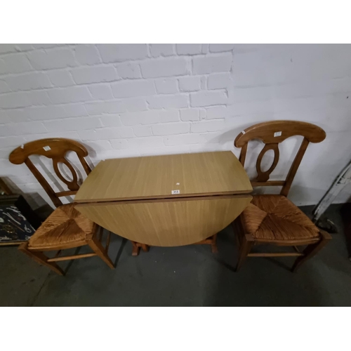 313 - A drop leaf dining table and 2 chairs