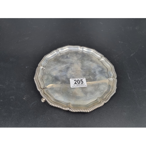 205 - A hallmarked silver footed card tray (diameter 8 inches and weight 410 grams) - very rubbed inscript... 