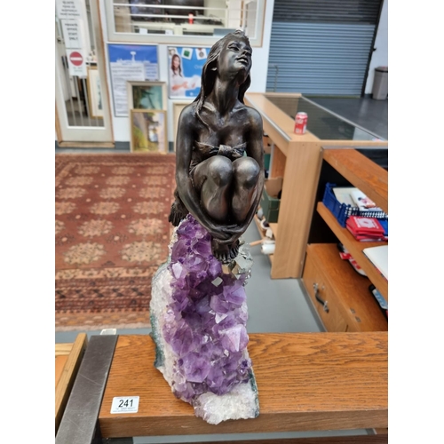 241 - A vidal metal figure of female form sitting on an amethyst geode