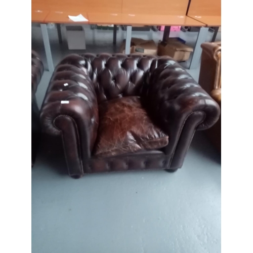 111 - A brown leather Chesterfield armchair