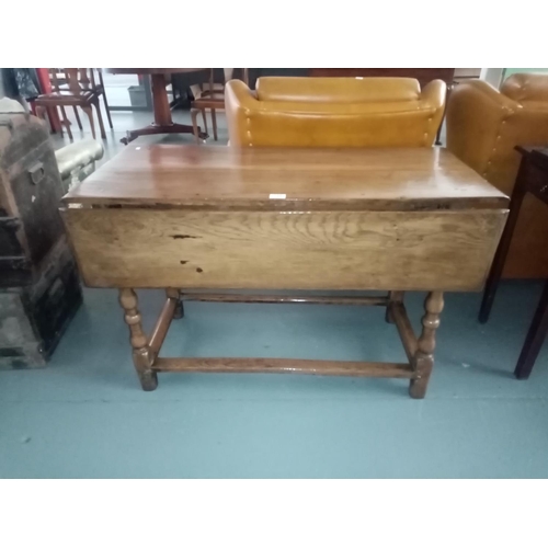 126 - An early oak drop leaf dining table with drawer