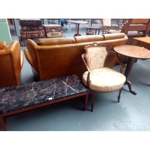 128 - An upholstered inlaid Victorian armchair, a mahogany tripod based lamp and a marble effect table.