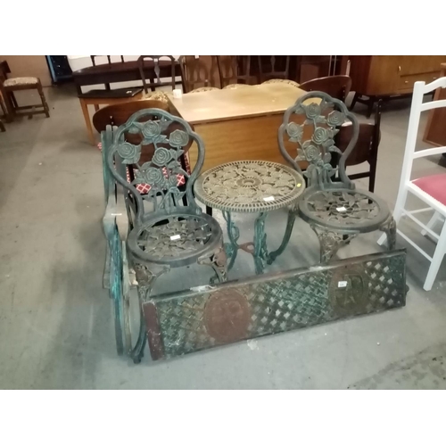 460 - Metal garden table and 2 chairs, benchends and back piece etc