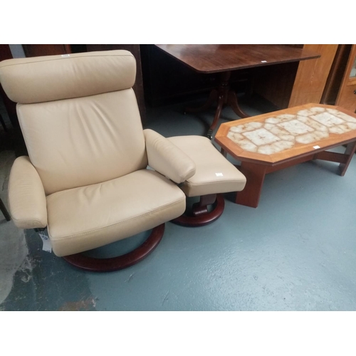 155 - A leather stressless reclining armchair with footstool and a teak tiled top G Plan coffee table