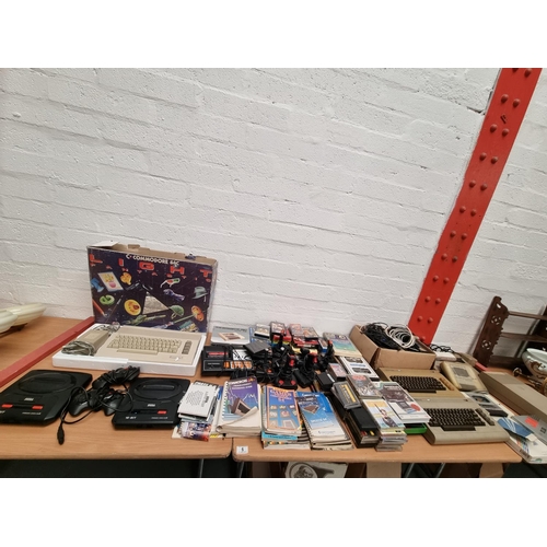 6 - A boxed Commodore 64 console with instructions and other Commodore 64 consoles, a Sega MegaDrive con... 