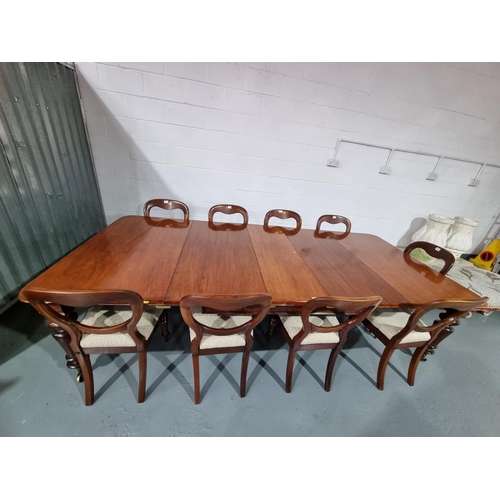 146 - A mahogany extending dining table with three extra leaves and nine balloon back chairs