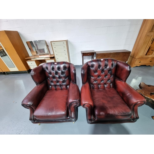 149 - Two Thomas Lloyd red leather Chesterfield wingback armchairs