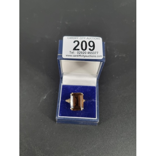 209 - A 9k gold dress ring with smokey topaz