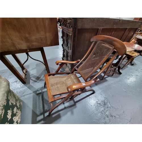 129 - A cane seated mahogany folding steamer chair