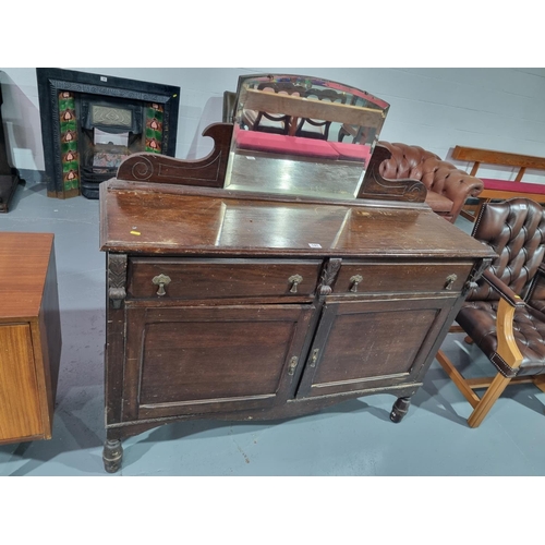 141 - An oak low mirrored back sideboard