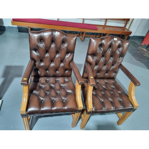 144 - Two brown leather Chesterfield armchairs