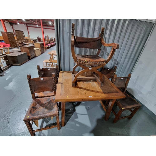 158 - An oak draw leaf dining table with four chairs and an oak X frame leather seated chair