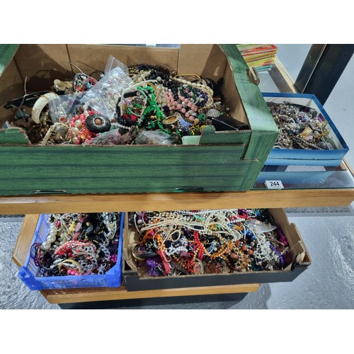 244 - A large quantity of costume jewellery (two shelves)