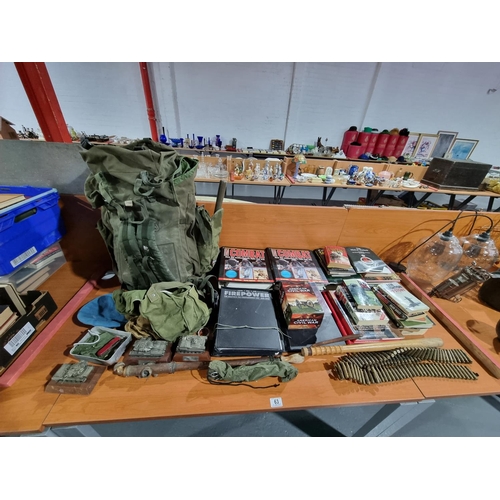 63 - War related items including magazines, military bag, truncheon etc