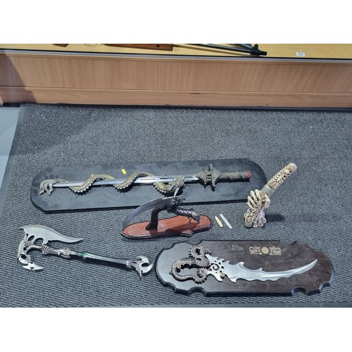 237 - A collection of ornamental swords, daggers, axes, etc