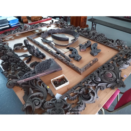 53 - A large carved wooden frame (needs attention) and other wooden carvings