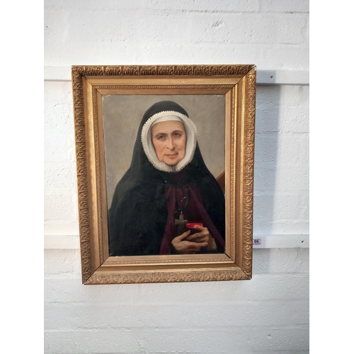 66 - An early oil on canvas framed painting of a religious nun - label to the reverse 