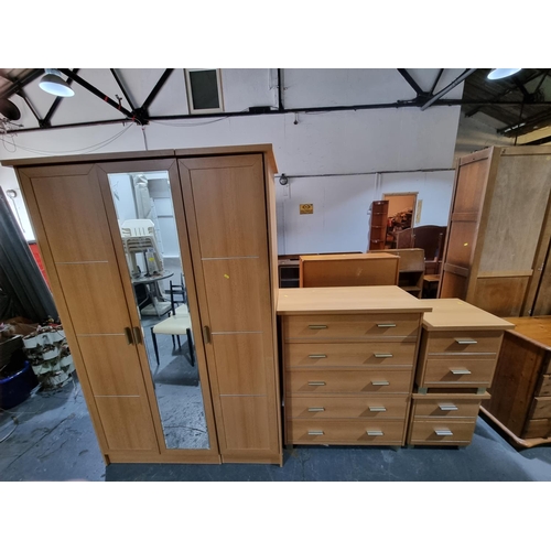 321 - Pine effect triple wardrobe, chest of drawers and 2 bedside units