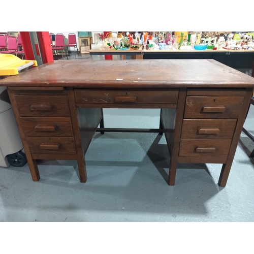 100 - An oak twin pedestal desk with leatherette topped inlay