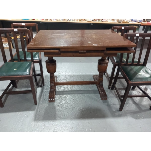 101 - An oak draw leaf table and 4 chairs