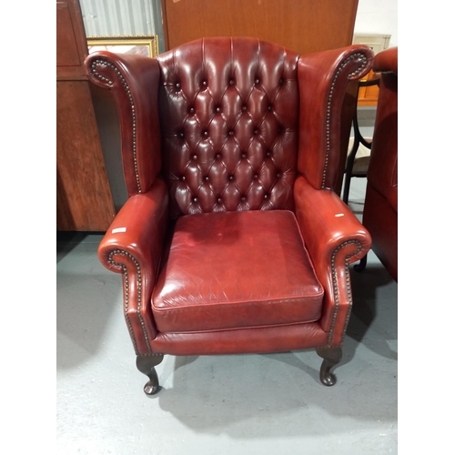 125 - A leather chesterfield wingback arm chair