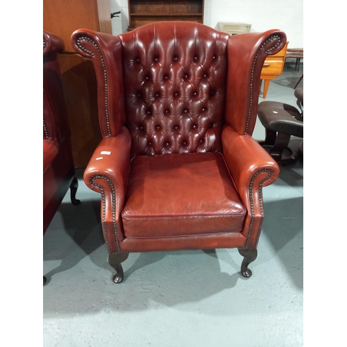 126 - A leather Chesterfield wingback arm chair