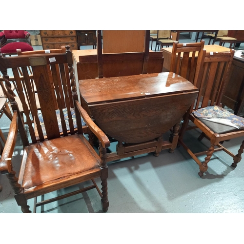 134 - An oak drop leaf dining table and four chairs