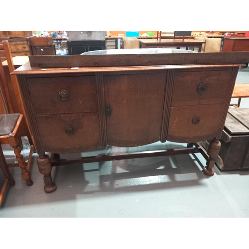 135 - An oak mirrored back sideboard