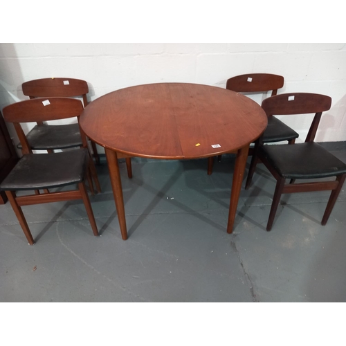 143 - A teak circular dining table and four chairs