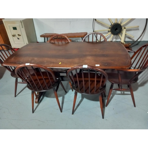 155 - An Ercol dining table and six chairs including two carvers