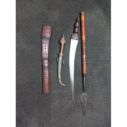 221 - A short spear, a Moroccan dagger in white metal sheath and a tourist short sword in leather scabbard