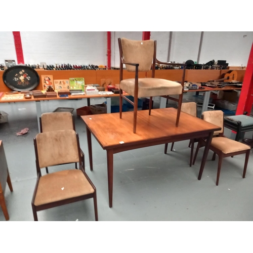 106 - A teak dining table and 4 chairs plus 1 carver