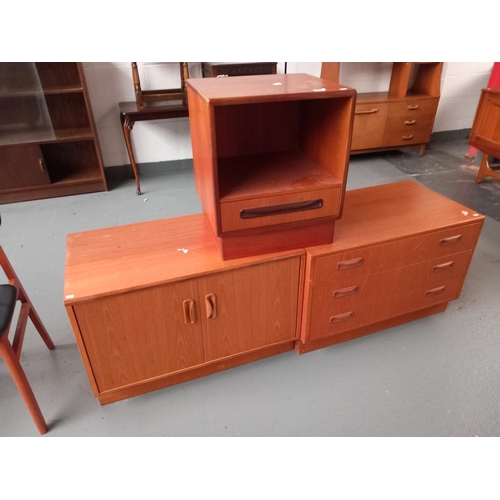 141 - A teak G Plan chest of drawers, bedside cabinet and one other cabinet