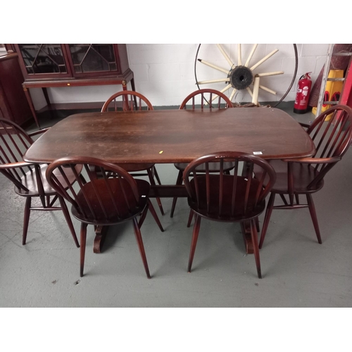 159 - An Ercol dining table and six chairs including two carvers