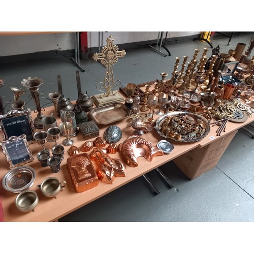 60 - A large selection of metalware including brass candlesticks, brass cross, copper jelly moulds etc