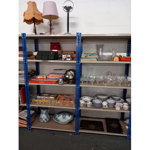 485 - 9 shelves of household items to include glassware, china, games, lamps etc