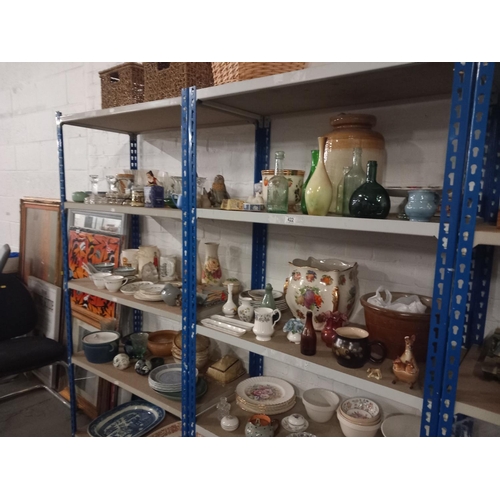 422 - 10 shelves of household items to include china, glassware, wicker baskets, etc