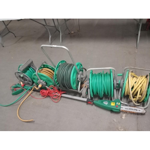 447 - 5 hose reel and an electric hedge trimmer