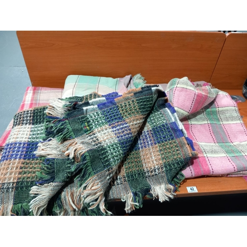 42 - Four woollen blankets and a Welsh waffle blanket