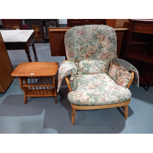 118 - An Ercol armchair (upholstery needs recovering) and an Ercol magazine rack